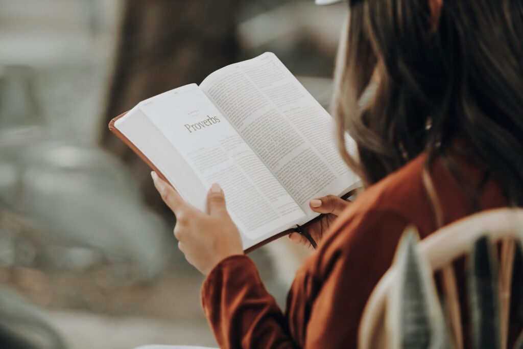 girl reading the book of Proverbs in the bible