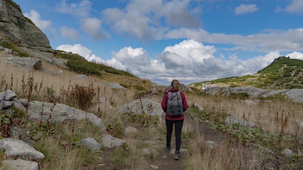 a person walking on a trail in a rocky area