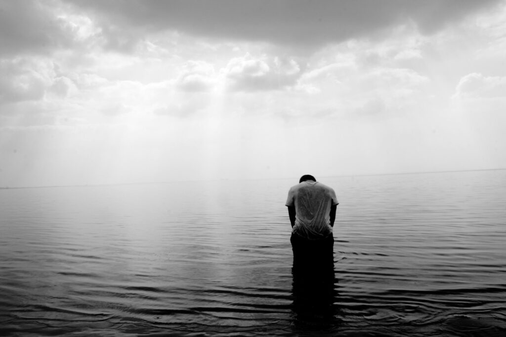 grayscale photography of person on beach