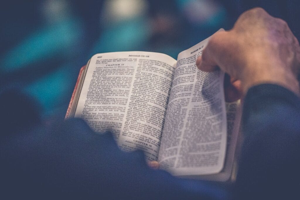 5 Powerful Bible Stories with Moral Lessons for Everyday Life person's hand holding book page