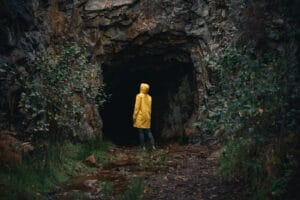 Blog a person in a yellow jacket is standing in a cave