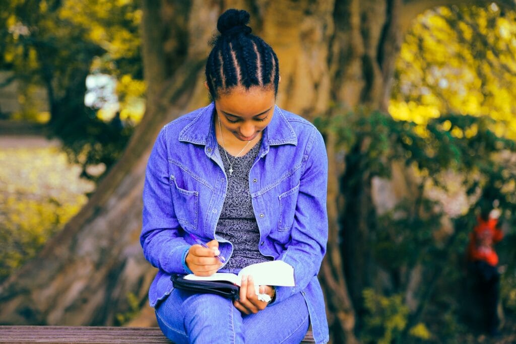 What If I Don't Believe the Rapture Is Happening in September? selective focus photography of woman reading book while sitting at bench