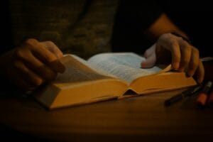 Blog a person is reading a book on a table