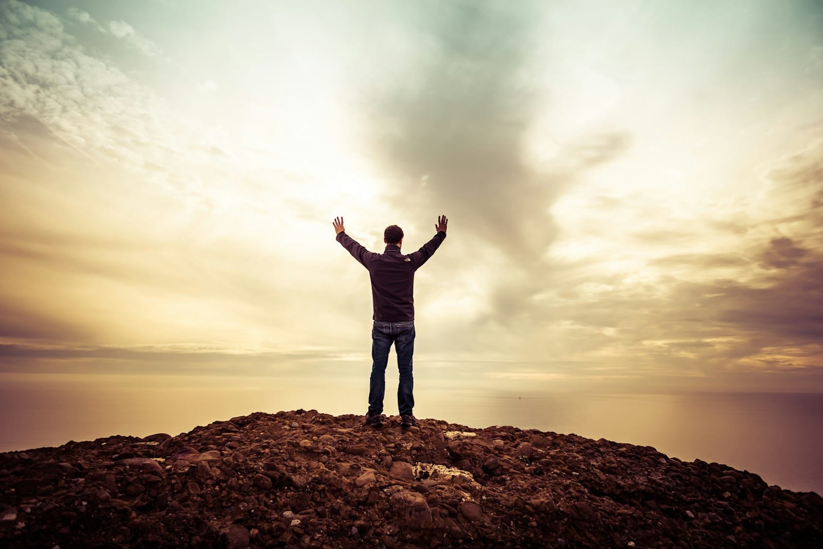 Blog man standing under orange sky