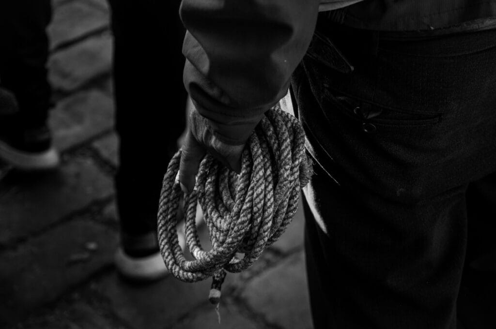 10 Essential Books Shedding Light on Human Trafficking a close up of a person holding a rope