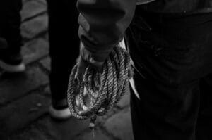 a close up of a person holding a rope